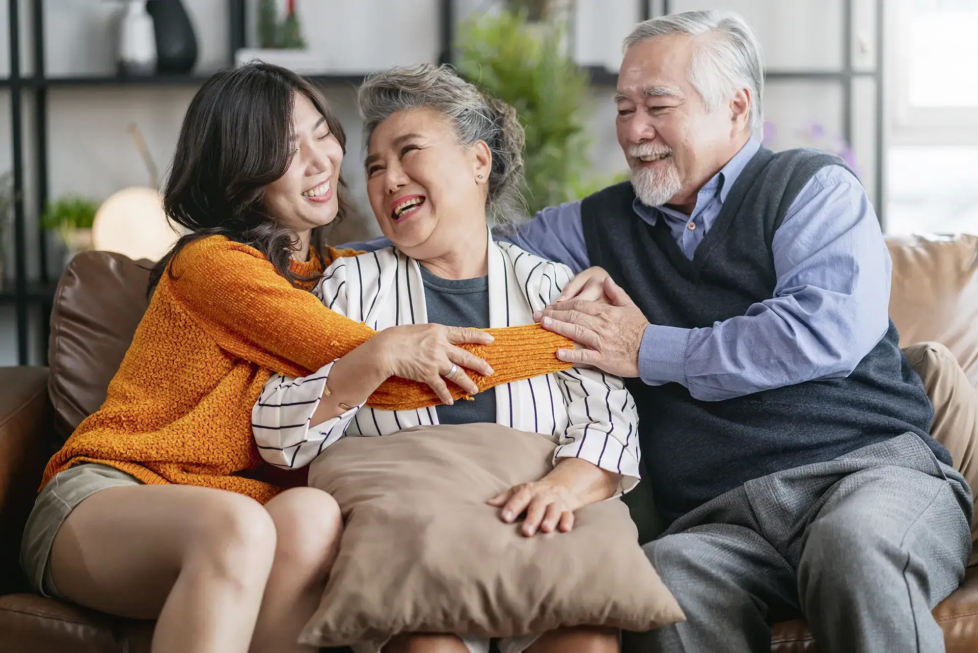 Three family members relaxing together at home